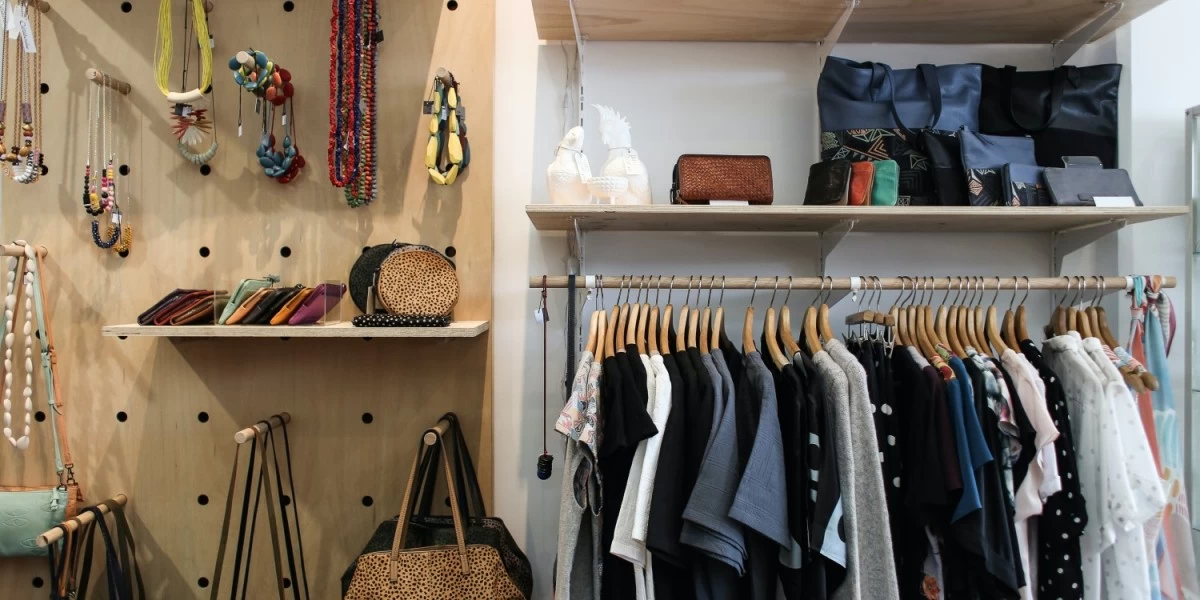 A wardrobe with its doors open, filled with clothes and other items that you need to declutter prior to your home move.