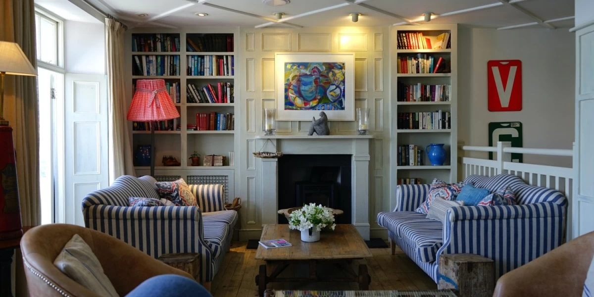 A comfy and cozy living room with two book shelves, shows plenty of potential for decluttering and organizing to make moving to a new home easier.
