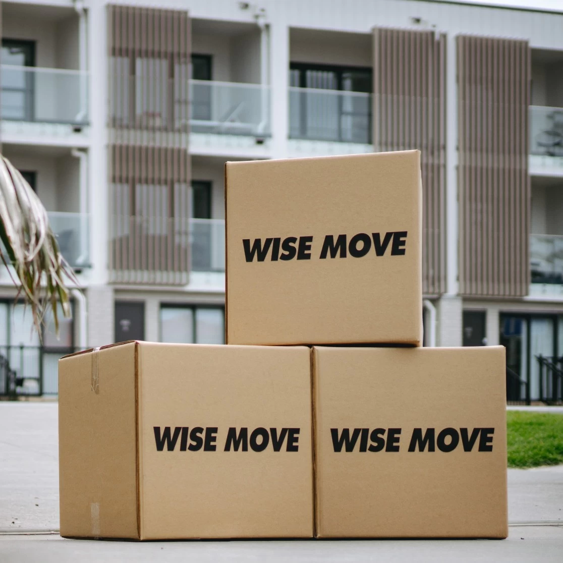 Moving boxes stacked outside a residential complex