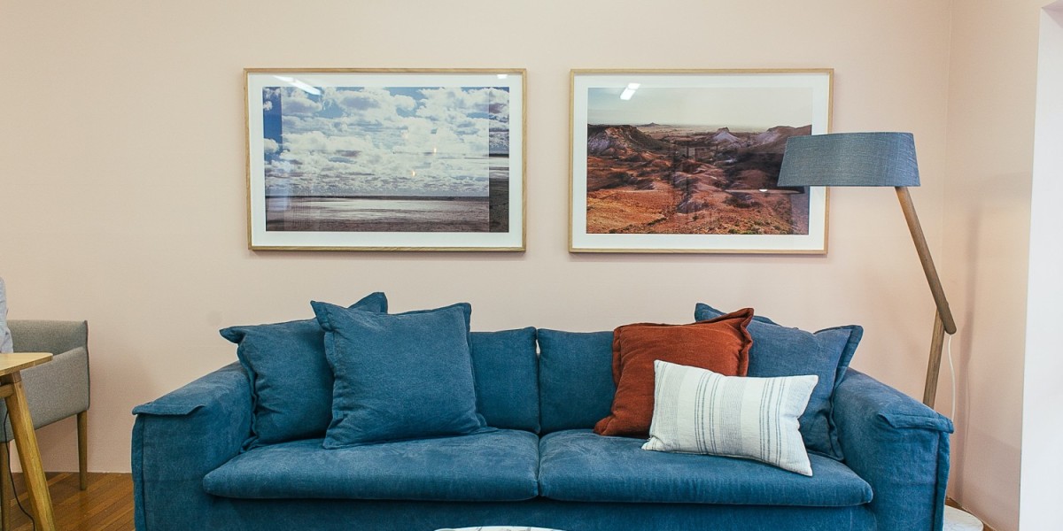 A cozy yet stylish living room featuring art and picture frames hung on the wall, perfect for those looking to spruce up a rental with a minimal budget