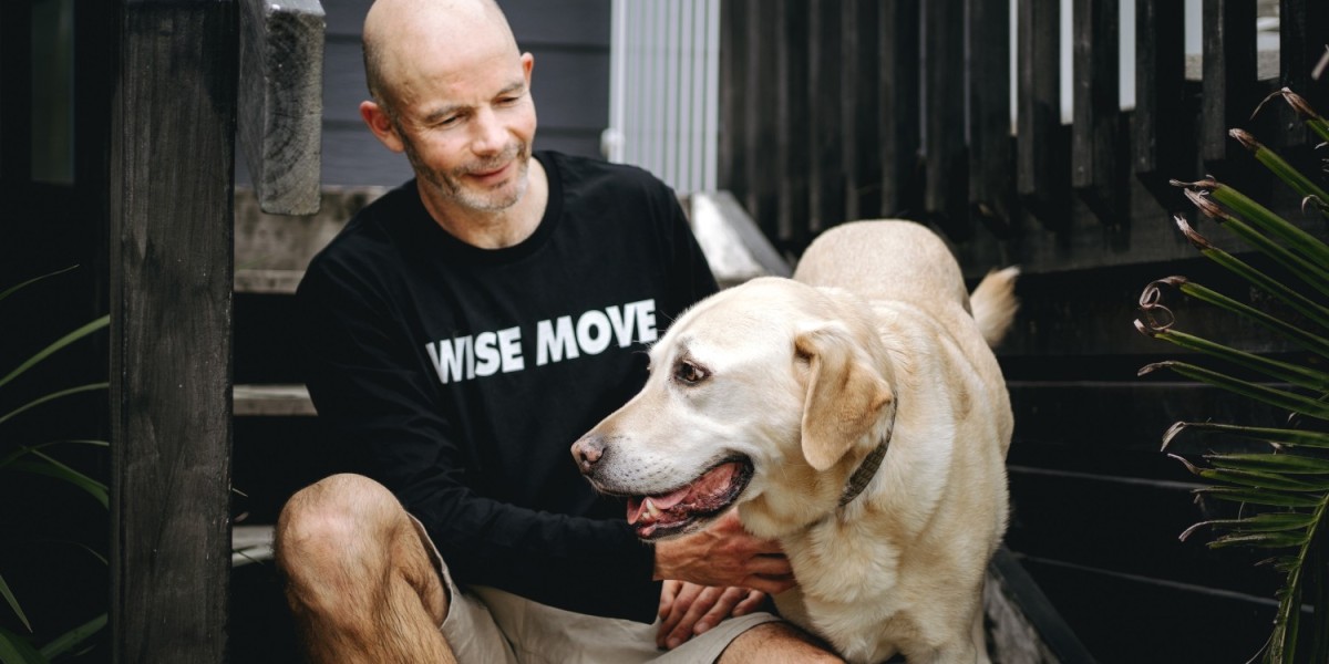 A pet mover petting a dog as it is about to be transported to its owners new home