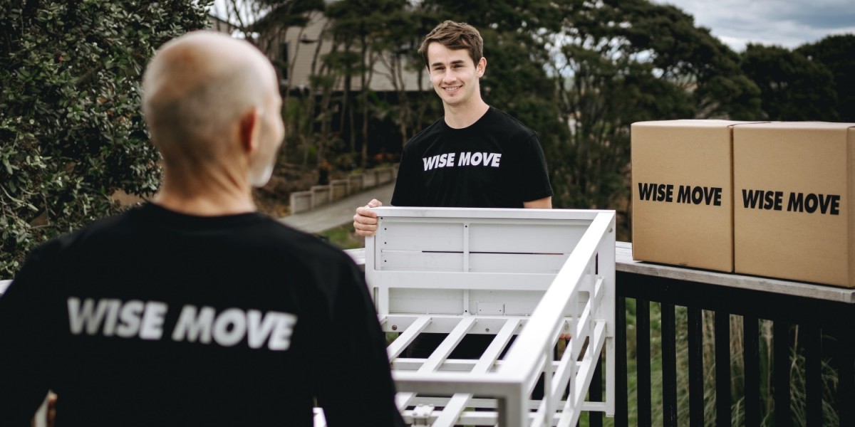 Two movers carrying a bed frame