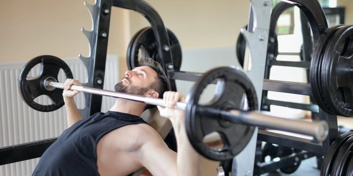 A man at the gym performing chest press