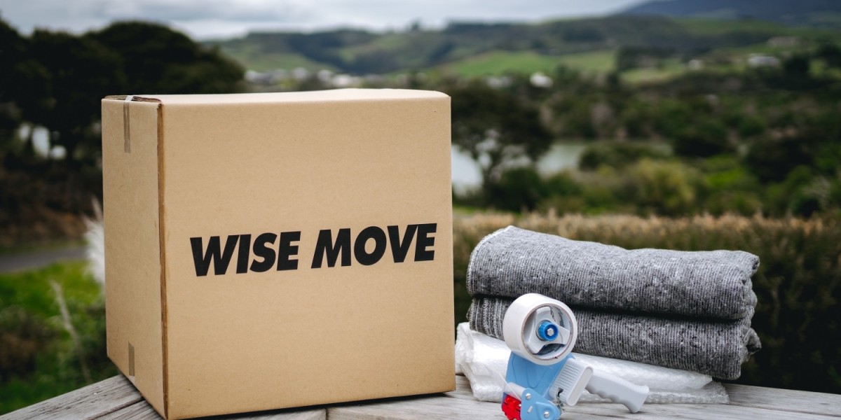 A moving box, along with moving blankets, bubble wrap, and a packing tape