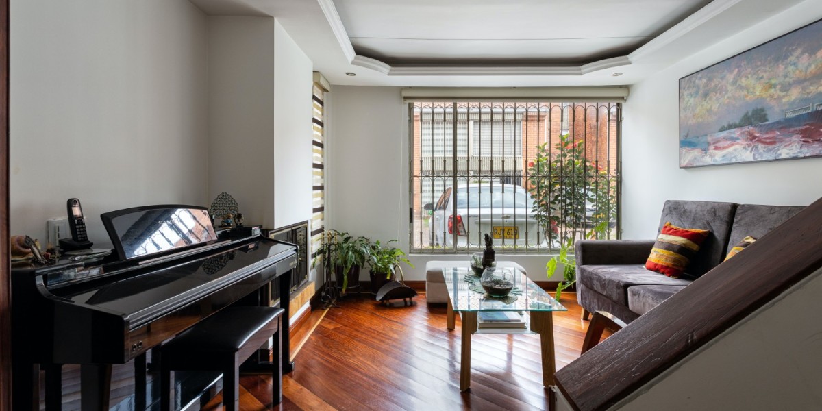 A living room with an upright piano on one corner, an item too heavy to move by yourself if your moving home.
