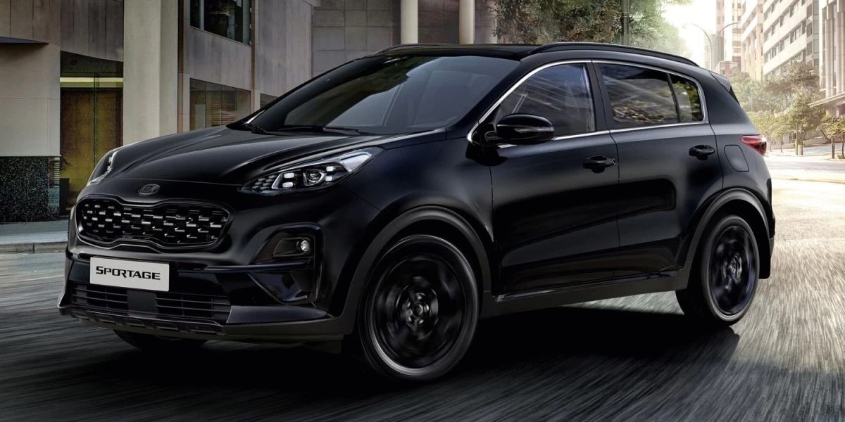 A black Kia Sportage in motion. This sleek and stylish SUV is among the most popular cars in New Zealand, with its attractive exterior and reliable, efficient engine.