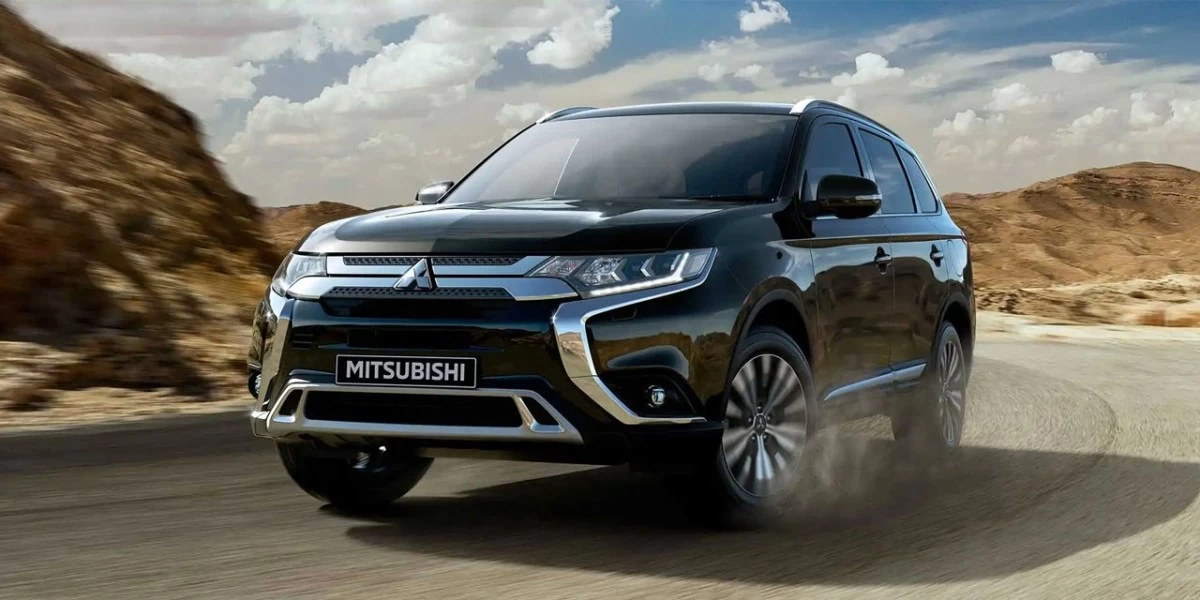 A black Mitsubishi Outlander with chrome trim, one of the most popular cars in New Zealand, known for its comfortable and spacious interior, rugged capability, and modern styling