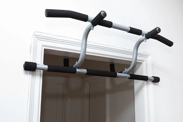 A pull-up bar mounted on a wall