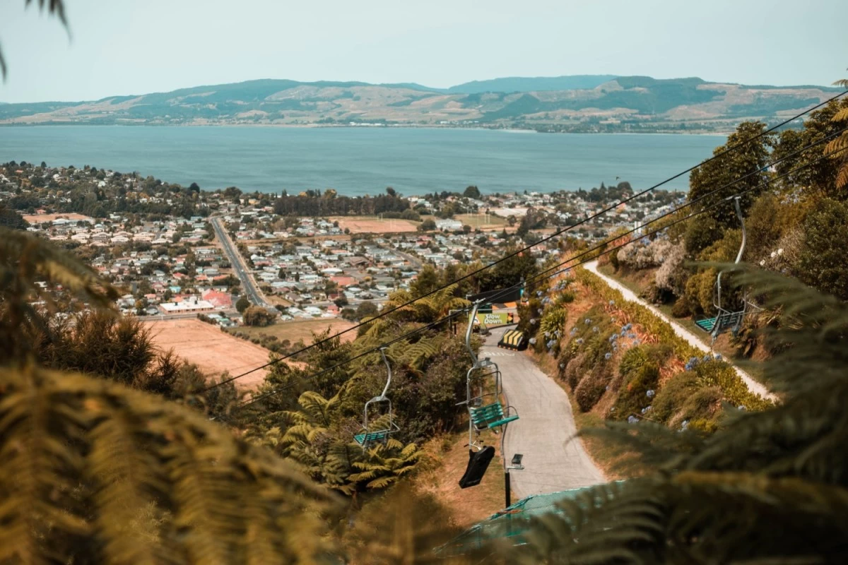 Rotorua, New Zealand showing lush green hills, clear bodies of water, and a vibrant cityscape