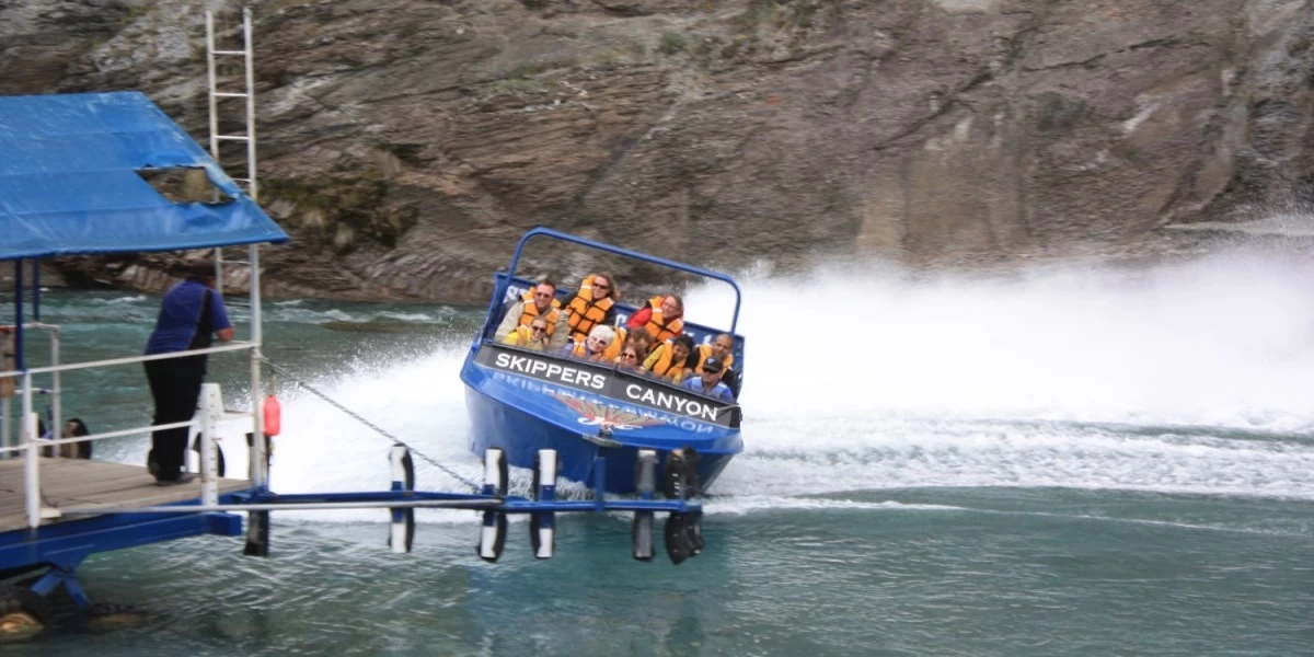 People enjoying a thrilling ride with Shotover Jet in Skipper's Canyon, Queenstown, which is known for its unique and spectacular scenery