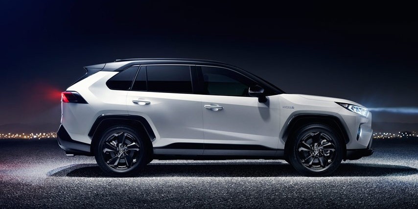 A white Toyota RAV4, widely recognized as the vehicle of choice in New Zealand and beyond due to its CO2 efficiency and practicality