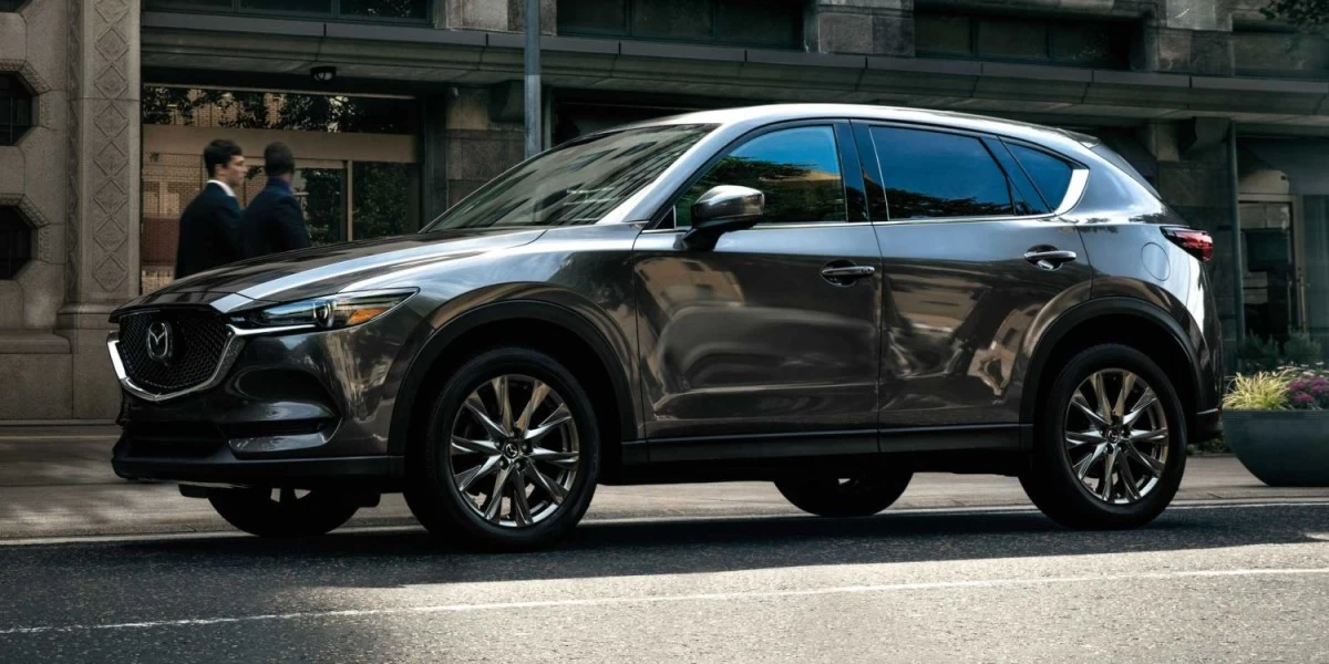 A black Mazda CX-5 SUV, wearing the distinct Mazda grille, aggressive lighting design and sleek lines, which has made it one of the most popular cars in New Zealand today.