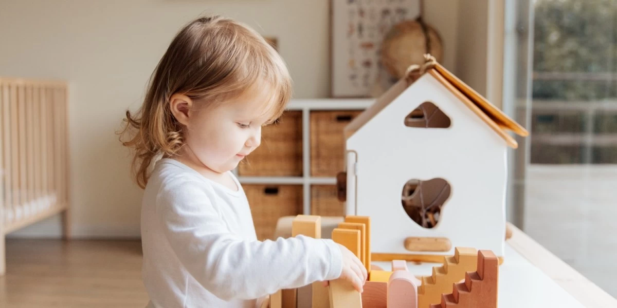 A child playing with her toys at their new house