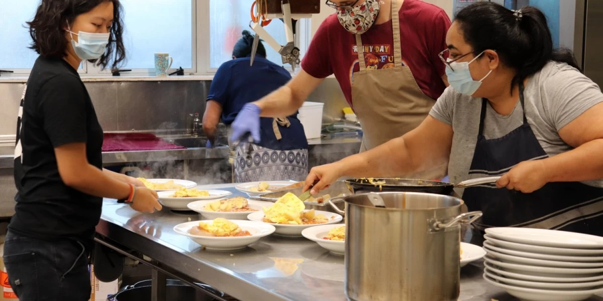 Volunteers at Soup Kitchen in Wellington preparing hot meals for unhoused men