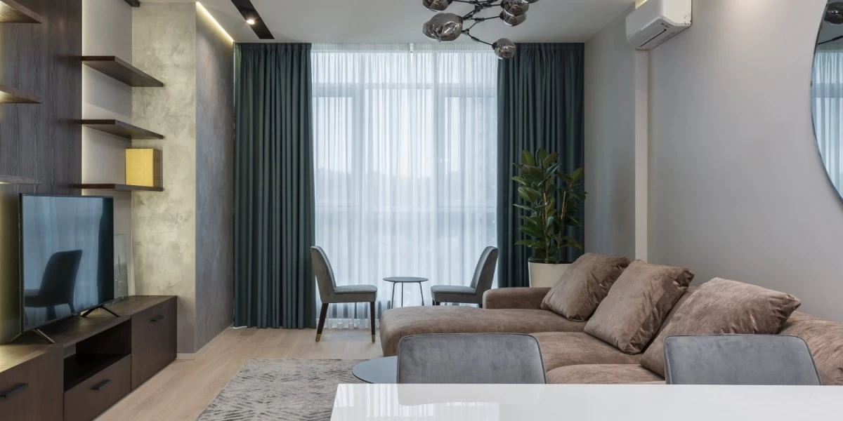 A grey and white curtains in a modern living room is a great way to spruce up a rental and make it feel like home on a budget