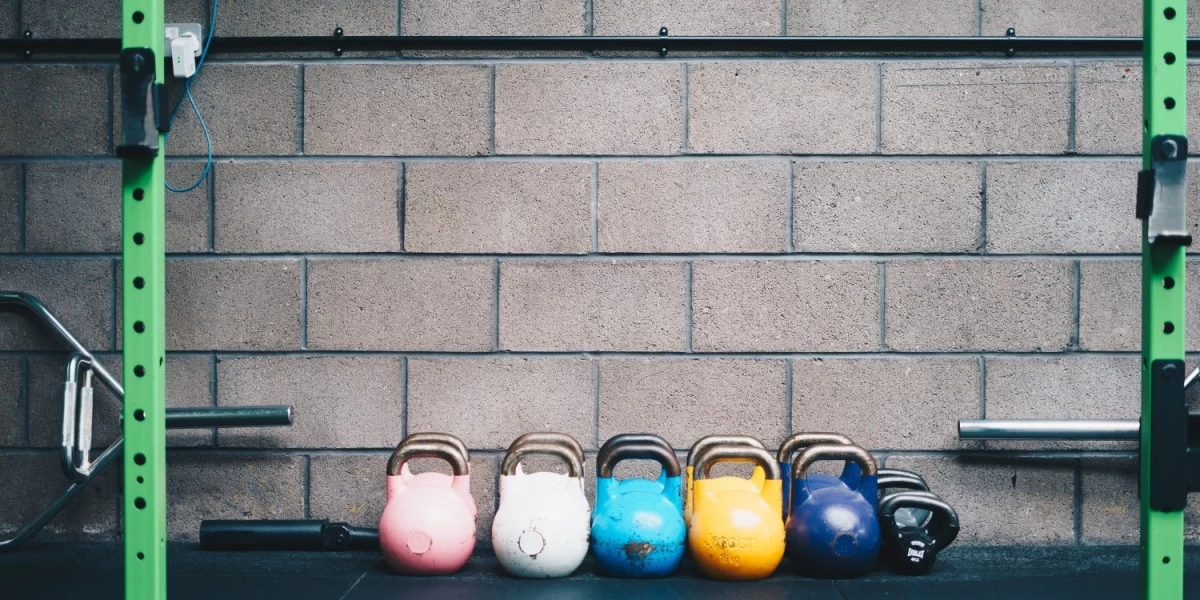 Kettlebells that are lined up on the gym floor