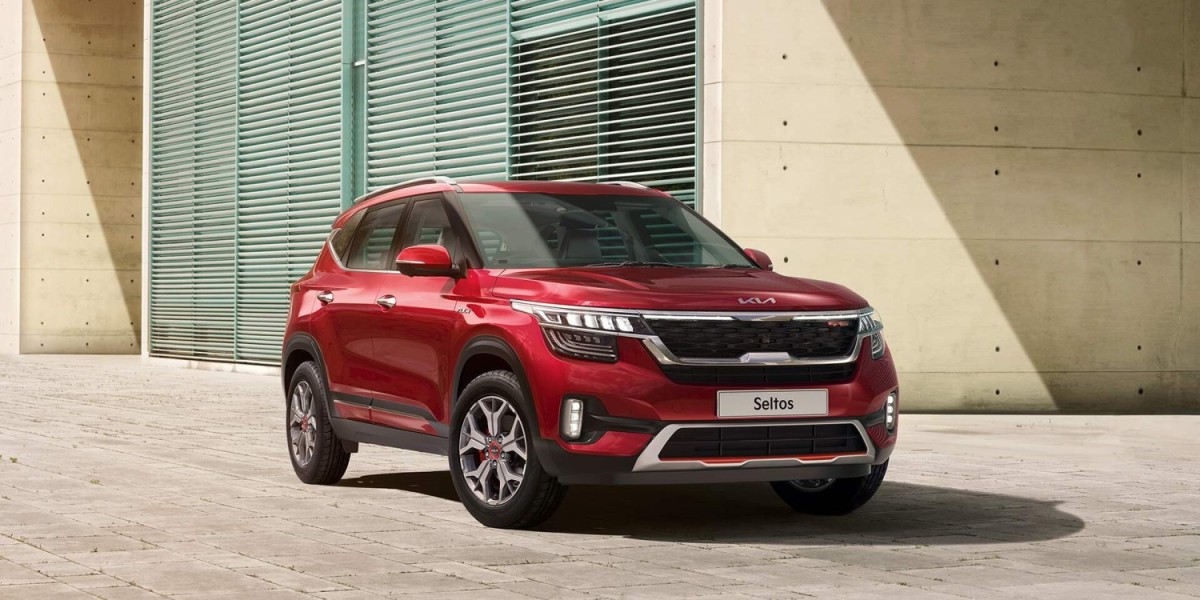 A red Kia Seltos sits proudly in a parking lot, decorated with the Kia logo and stylistic lines, a part of the ever-popular Kia line of cars in New Zealand.