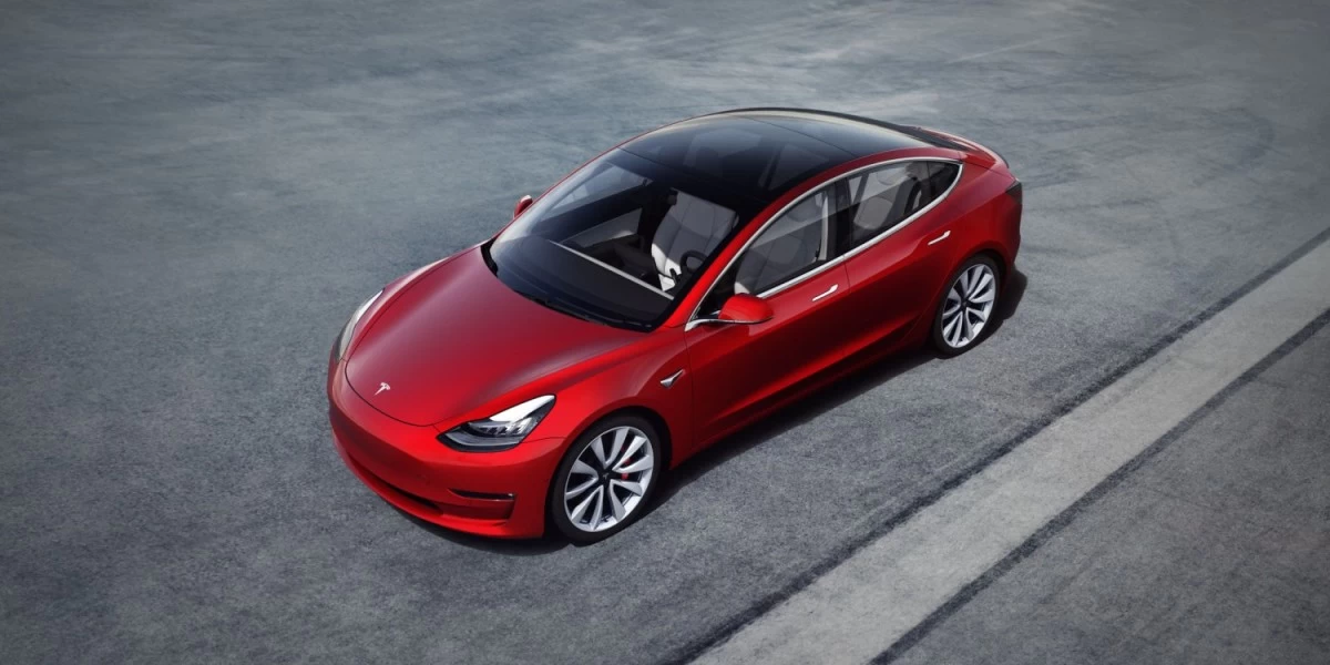 A red Tesla Model 3, one of the most popular electric car in New Zealand due to its attractive design, advanced safety features, and long driving range