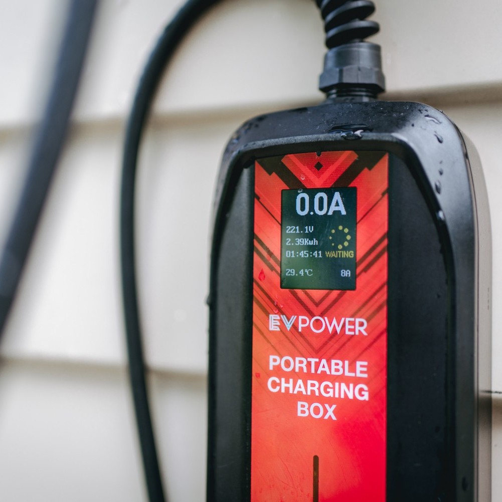 An electric car is plugged into a charging station, convenient charging but can take up some time compared to refueling a petrol-powered vehicles