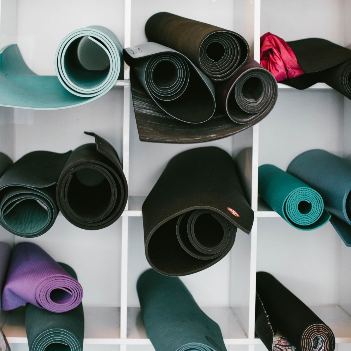Yoga mats stored in a shelving unit