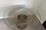 Glass table top with heavy metal base