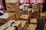Assorted household items already packed into cardboard boxes - most Mc...