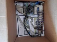 Box of motorbike plastics and one rear suspension