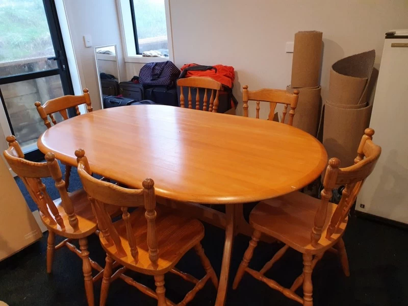 Table and six chairs, The table has a glass top fully wrapped.