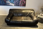 Two double leather sofas and a 120 cm round table