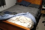 Queen bed with wooden head-board 1m high, base as long planks and foot...