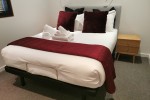 Queen bed, 2 small bedside tables, small 2 seater dining table and 2 c...