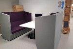 Office Pod and table two large chairs and a talbe between