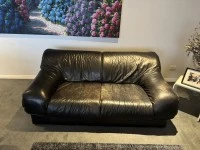 Two double leather sofas and a 120 cm round table