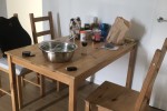 3 seats sofa, one seat sofa, a small dining table and four chairs that...