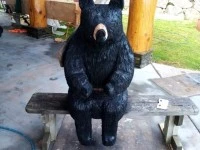 2 carved black bears
