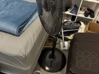 Desk, Chair, Suitcase with clothes, Pedestal fan, Ultrawide monitor