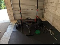 Packed Squat rack, Barbell, Gym mats and weights