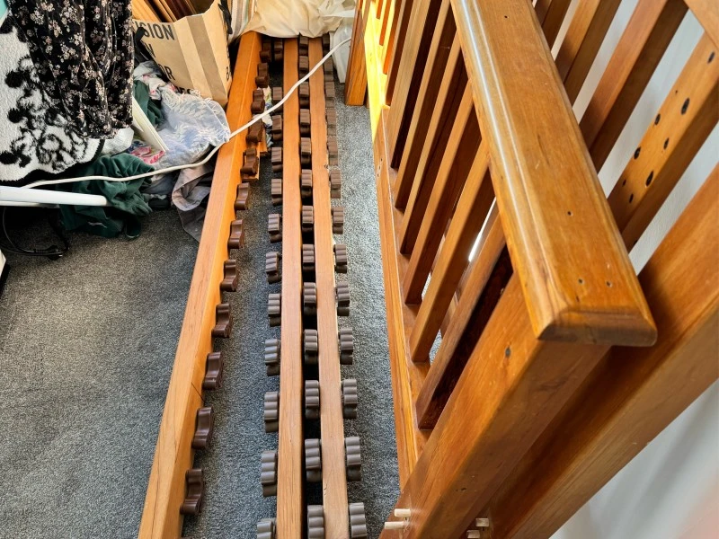 Wooden bed ends and slats and three attaching beams