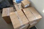 1 box that are full of documents and items, 1 box that has a Desktop p...