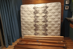 Four-poster bed and mattress disassembled