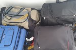 1 x oval table, 5 packed boxes, 5 packed suitcases