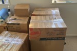 1 box that are full of documents and items, 1 box that has a Desktop p...