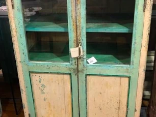 One wooden cabinet , has 2 small glass windows in front,