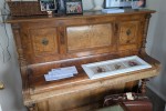 Vintage wooden upright piano with iron frame