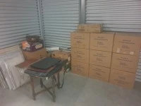 Boxes, 2 small tables, Wrapped paintings