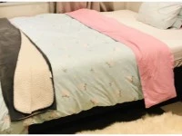 Queen bed, Drawers, A heater, pillows, duvet, and three small boxes.