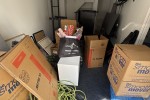 King bed, Shelving units, Shelving units, Lots of boxes, 2 plastic cha...