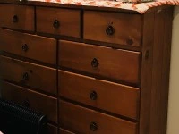 Queen bed, Drawers, A heater, pillows, duvet, and three small boxes.