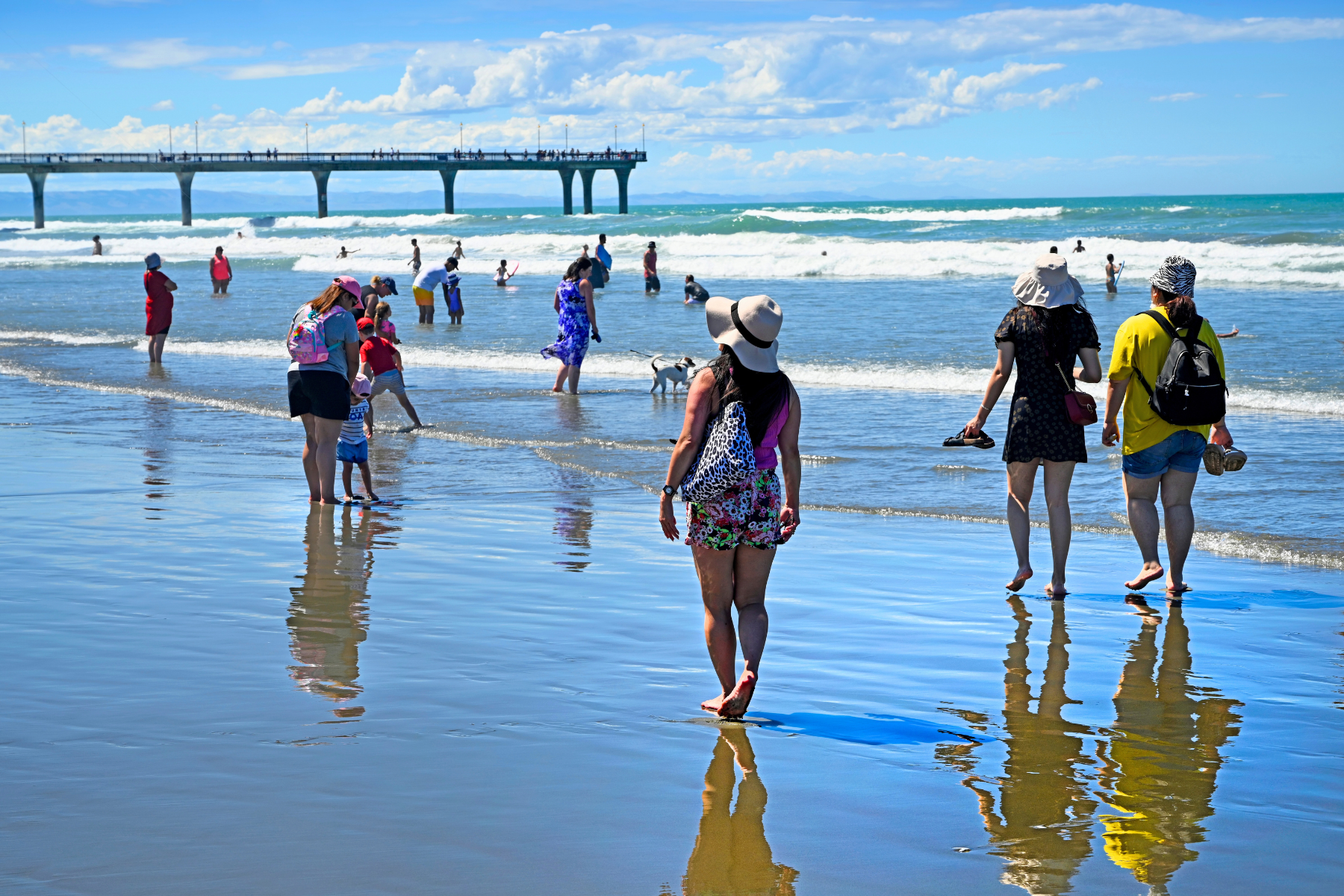 Locals on beach dressed for hot summer weather