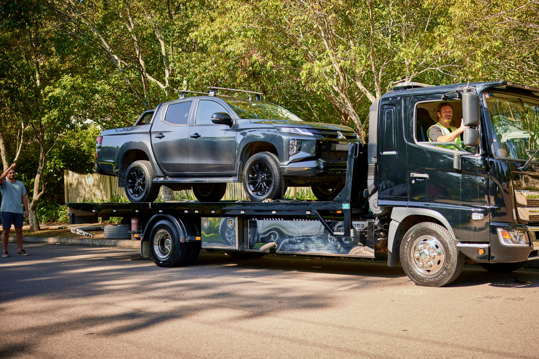 Car on open transport truck for door-to-door car transport